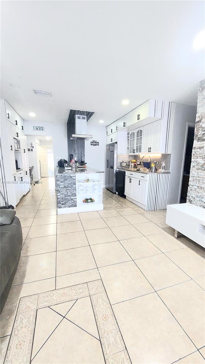 2145 Southwest 76th Avenue Miami, FL 33155 - Photo 9 of 28 a large white kitchen with cabinets and a stove top oven