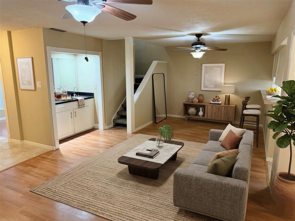 2051 Embassy Way Carrollton, TX 75006 - Photo 2 of 20 Living room with ceiling fan and light wood finished floors