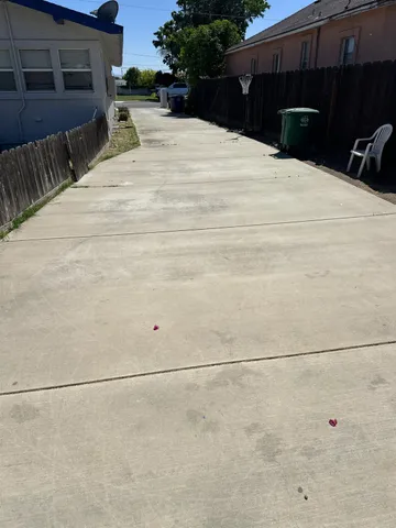 a view of a house with a yard and wooden fence