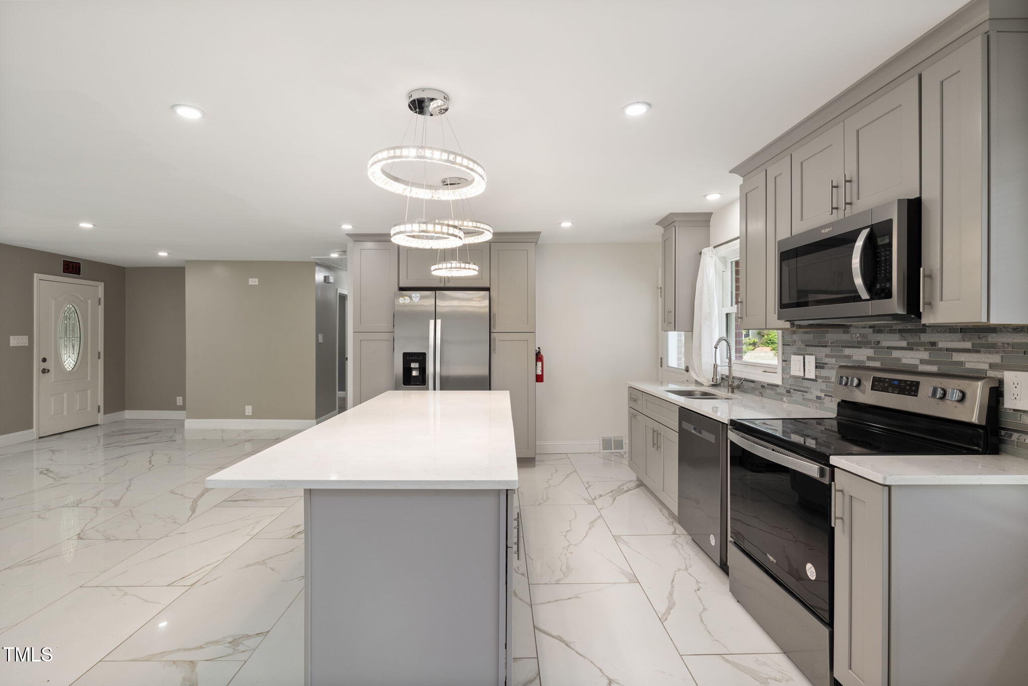 2315 Oxford Road Henderson, NC 27536 - Photo 13 of 62 a large kitchen with a large counter top stainless steel appliances and cabinets