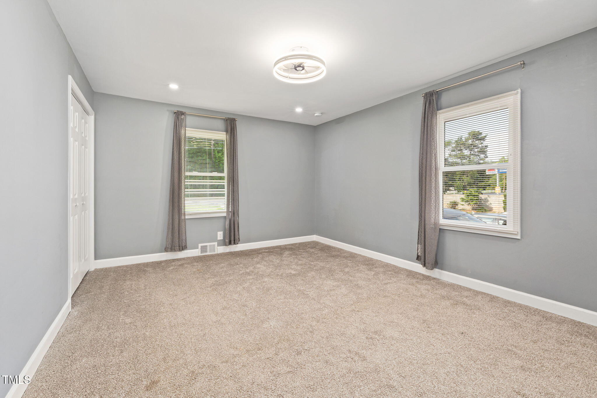2315 Oxford Road Henderson, NC 27536 - Photo 15 of 62 an empty room with windows and closet