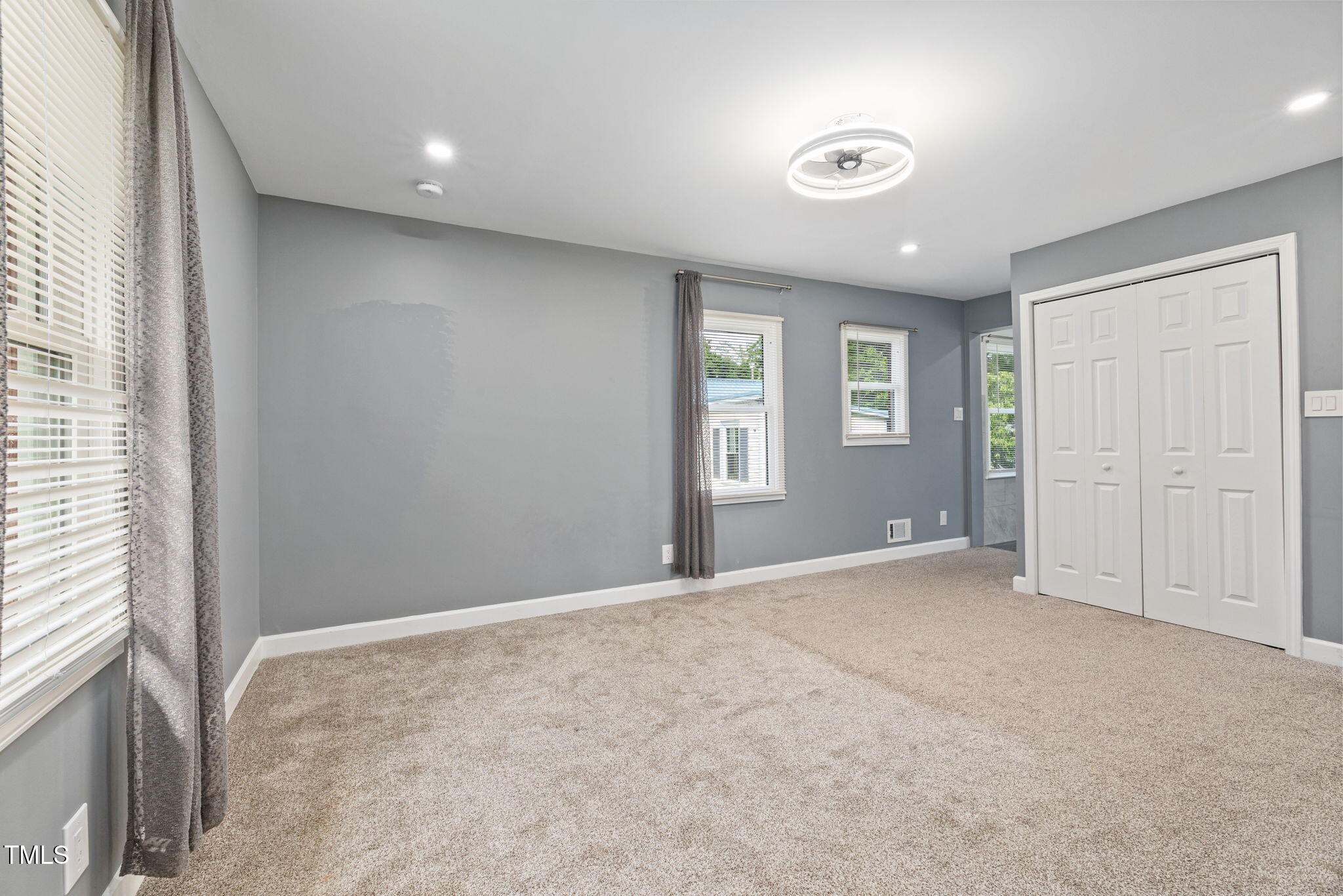 2315 Oxford Road Henderson, NC 27536 - Photo 17 of 62 an empty room with windows and closet