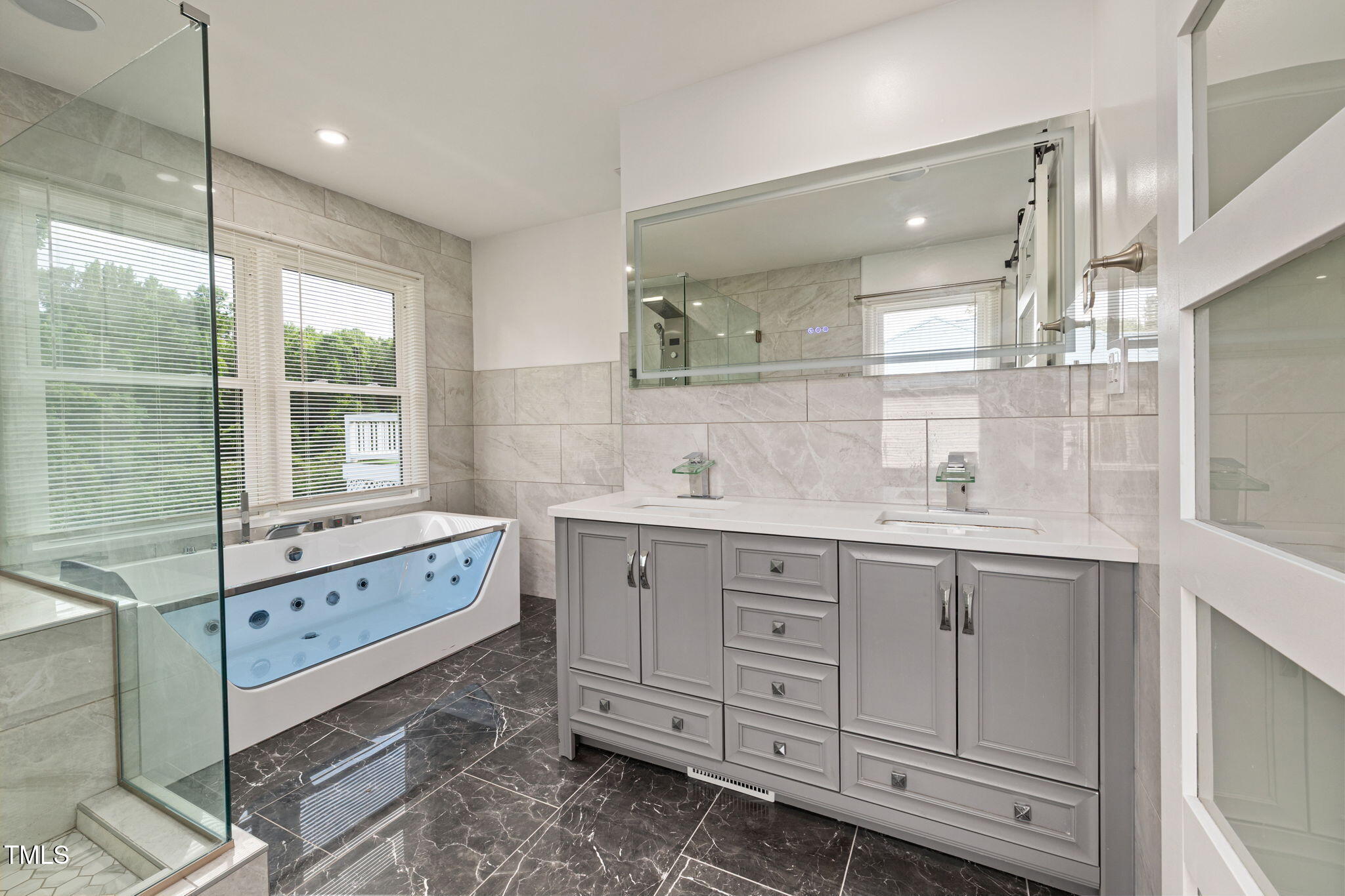 2315 Oxford Road Henderson, NC 27536 - Photo 21 of 62 a bathroom with double vanity sink a mirror a window and vanity