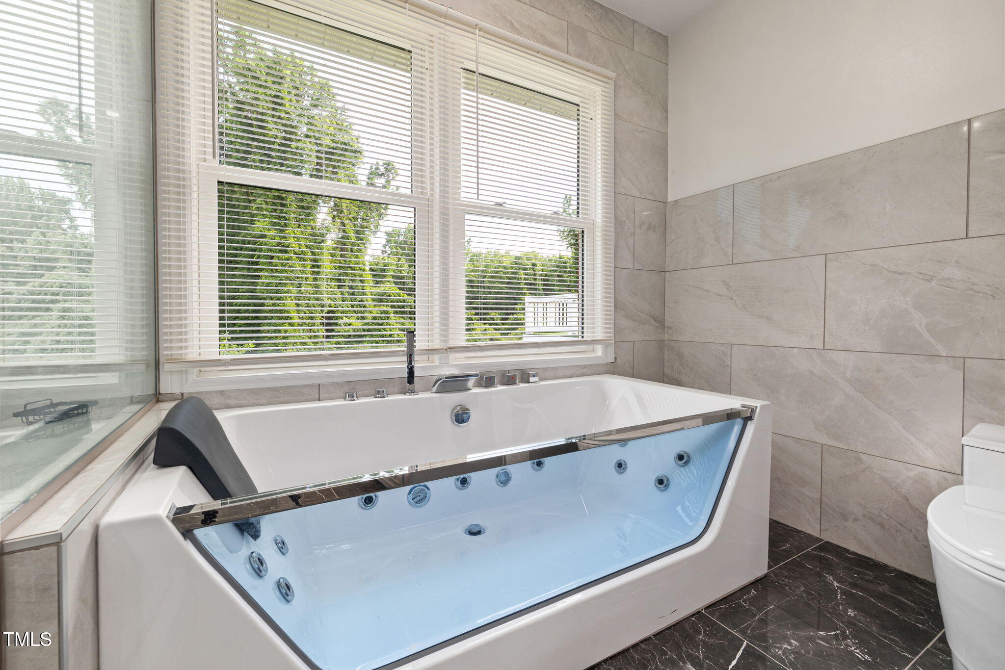 2315 Oxford Road Henderson, NC 27536 - Photo 22 of 62 a bath tub sitting in a bathroom next to a window