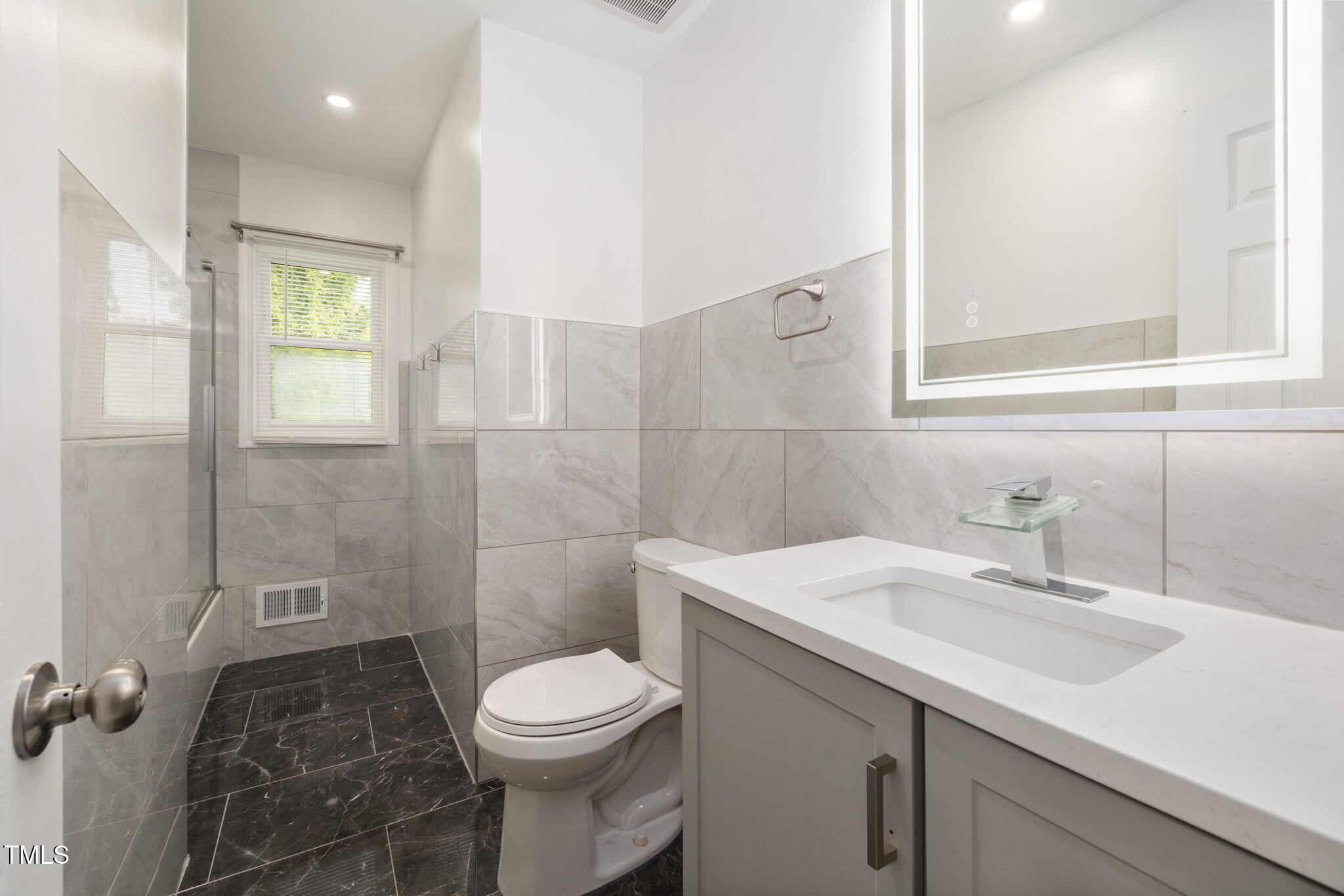 2315 Oxford Road Henderson, NC 27536 - Photo 28 of 62 a bathroom with a sink a toilet and shower