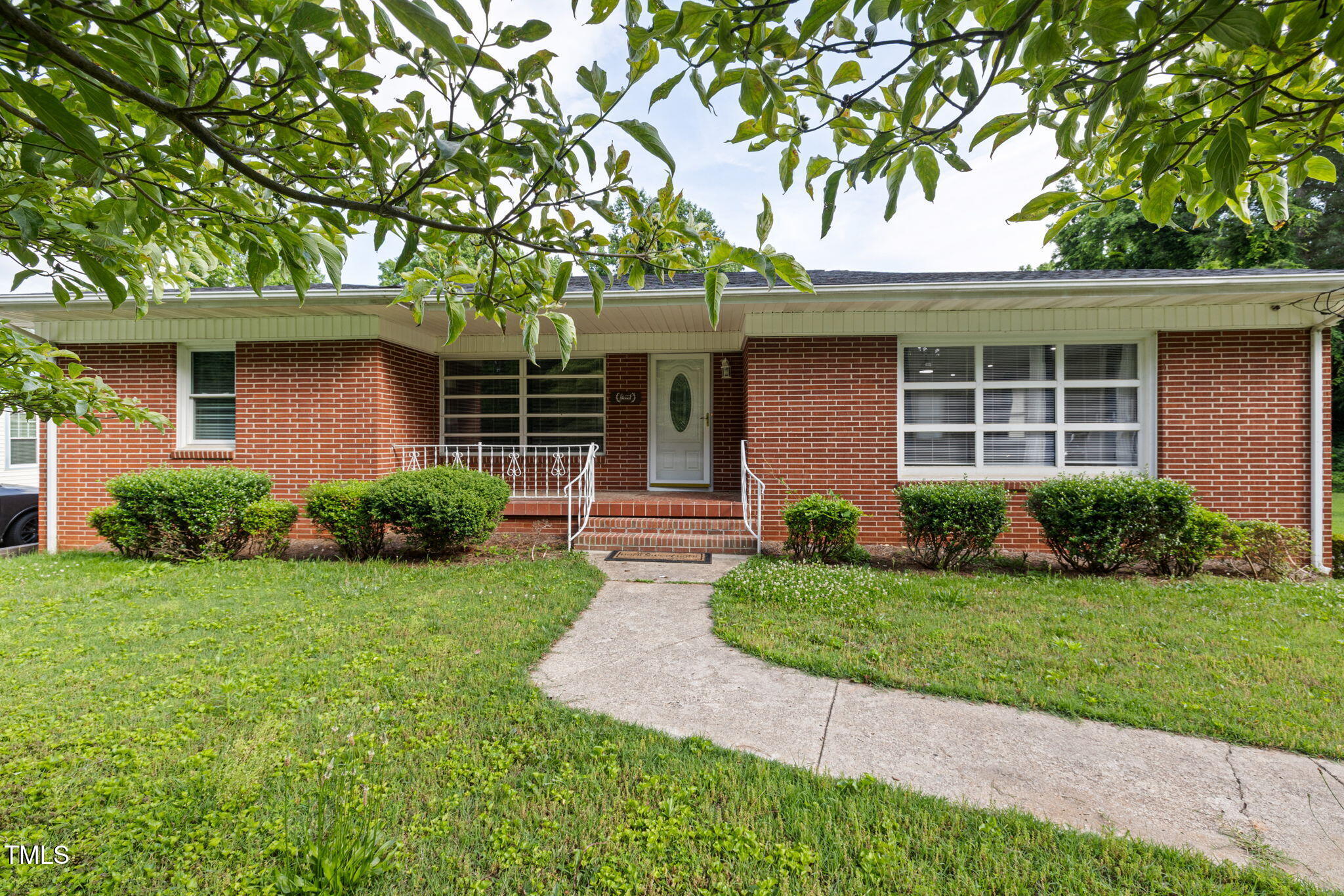 2315 Oxford Road Henderson, NC 27536 - Photo 2 of 62 a front view of a house with a yard and garage