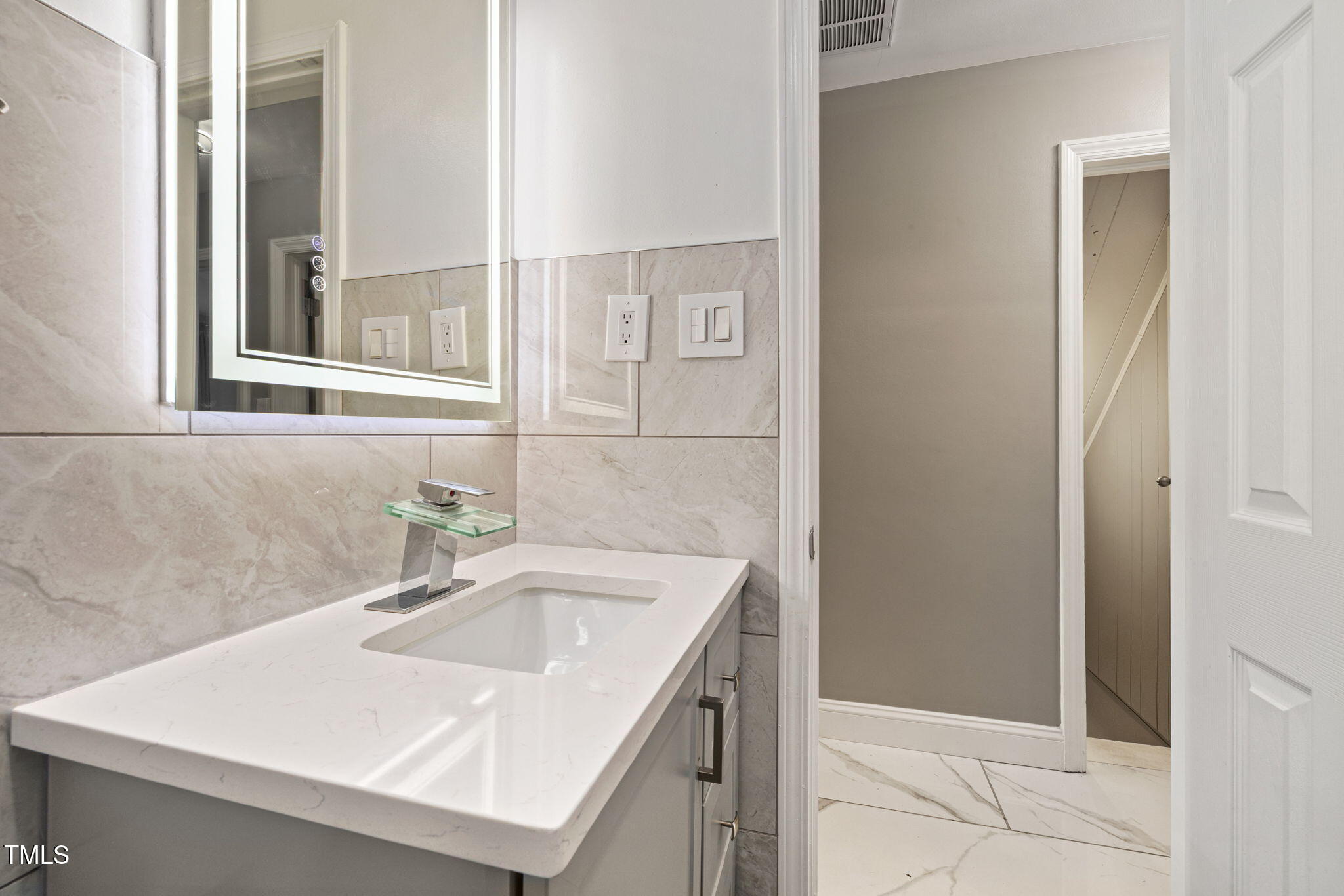 2315 Oxford Road Henderson, NC 27536 - Photo 31 of 62 a bathroom with a sink and a mirror