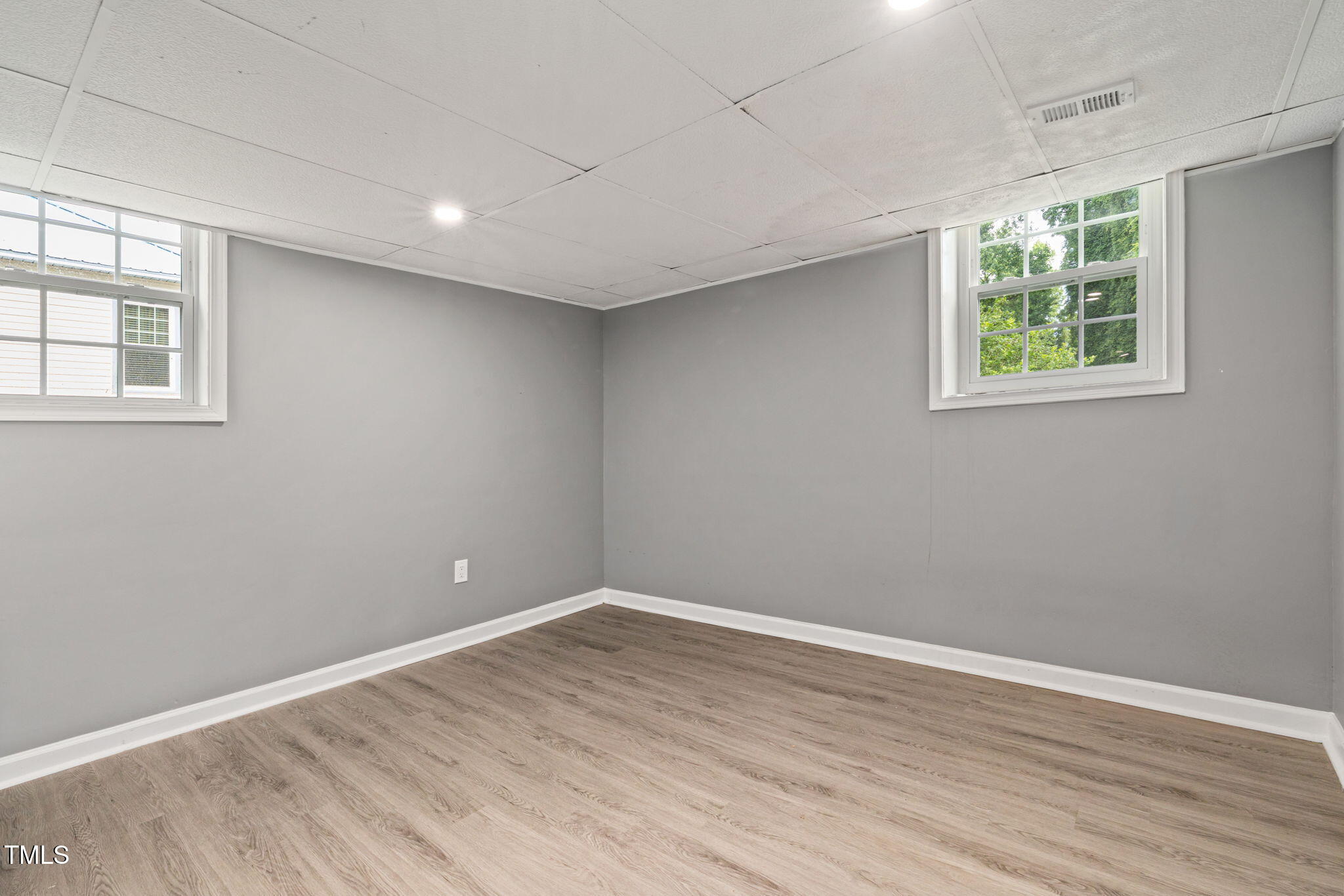 2315 Oxford Road Henderson, NC 27536 - Photo 38 of 62 an empty room with wooden floor and windows