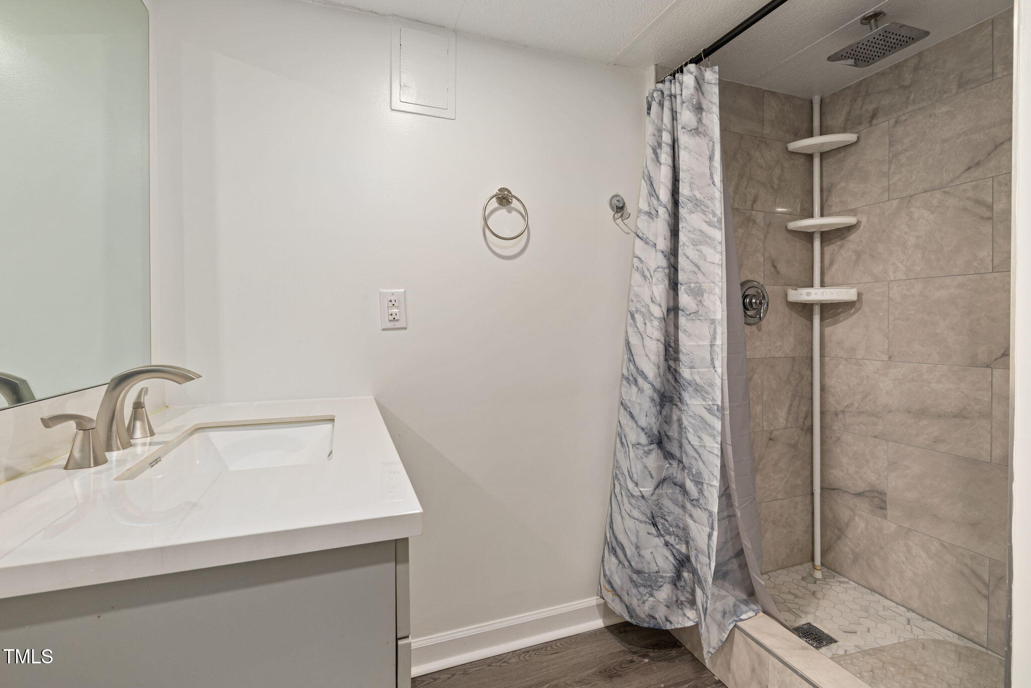 2315 Oxford Road Henderson, NC 27536 - Photo 41 of 62 a bathroom with a shower a sink and a mirror