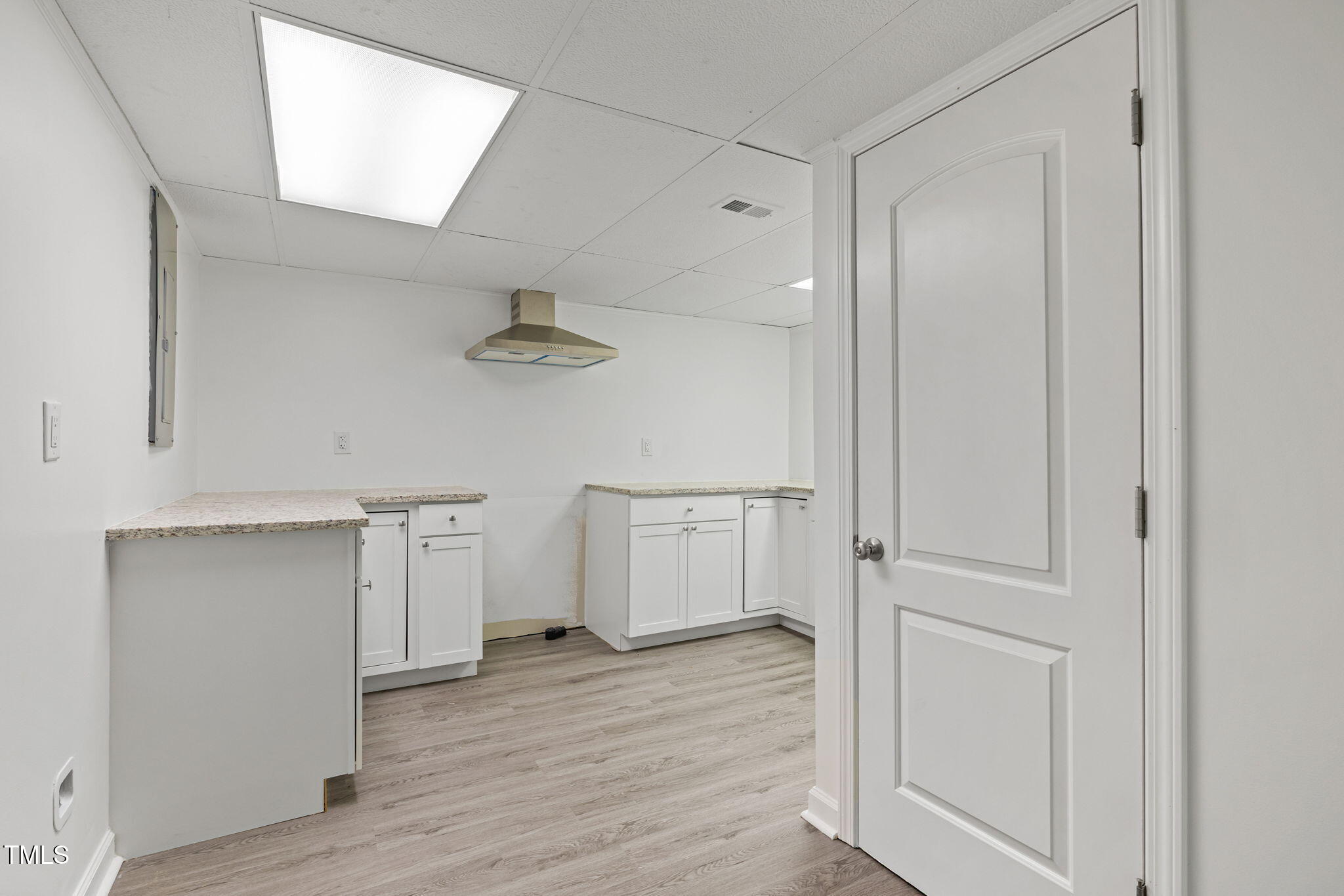 2315 Oxford Road Henderson, NC 27536 - Photo 42 of 62 an empty room with wooden floor and cabinet