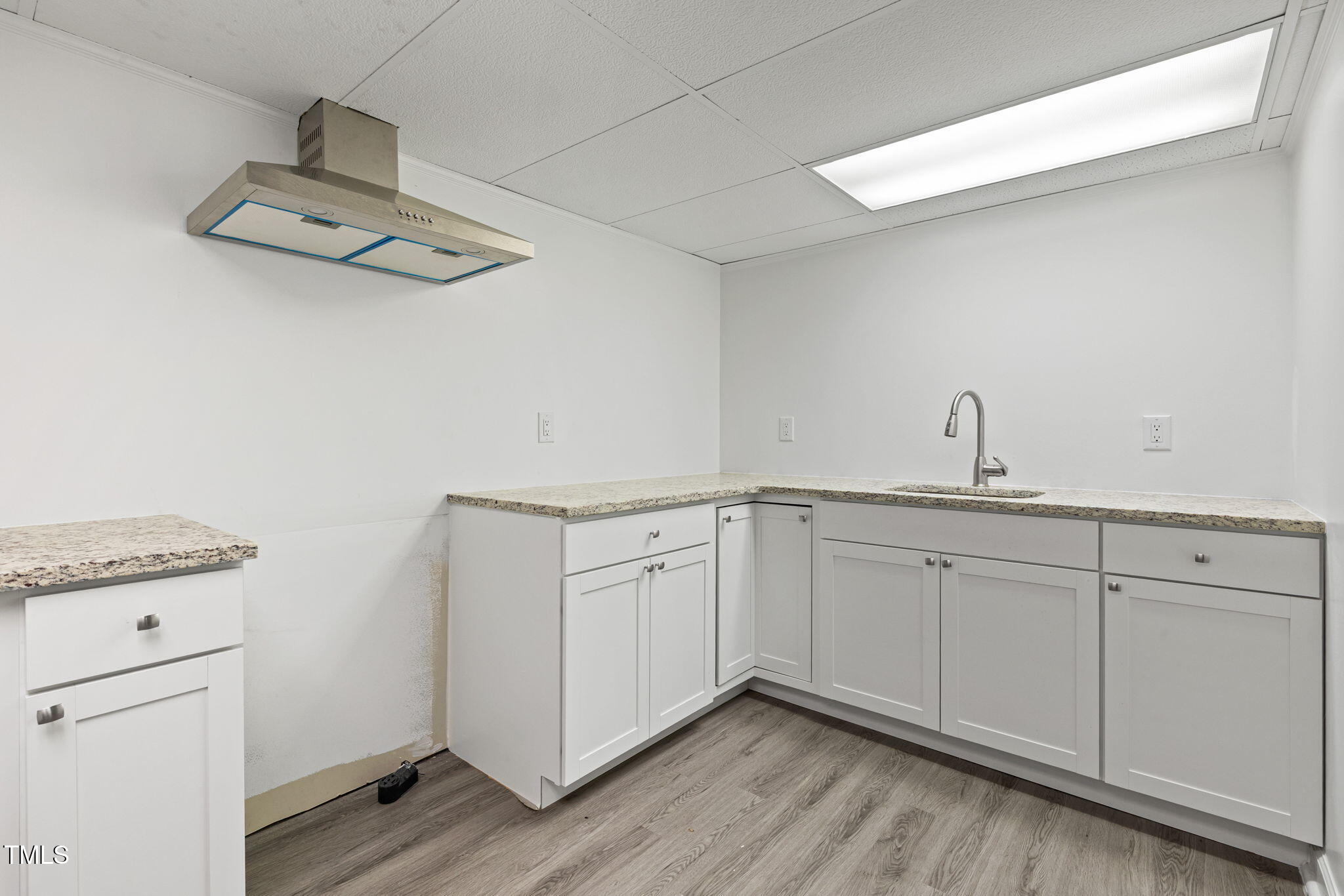 2315 Oxford Road Henderson, NC 27536 - Photo 43 of 62 a room with cabinets and wooden floor