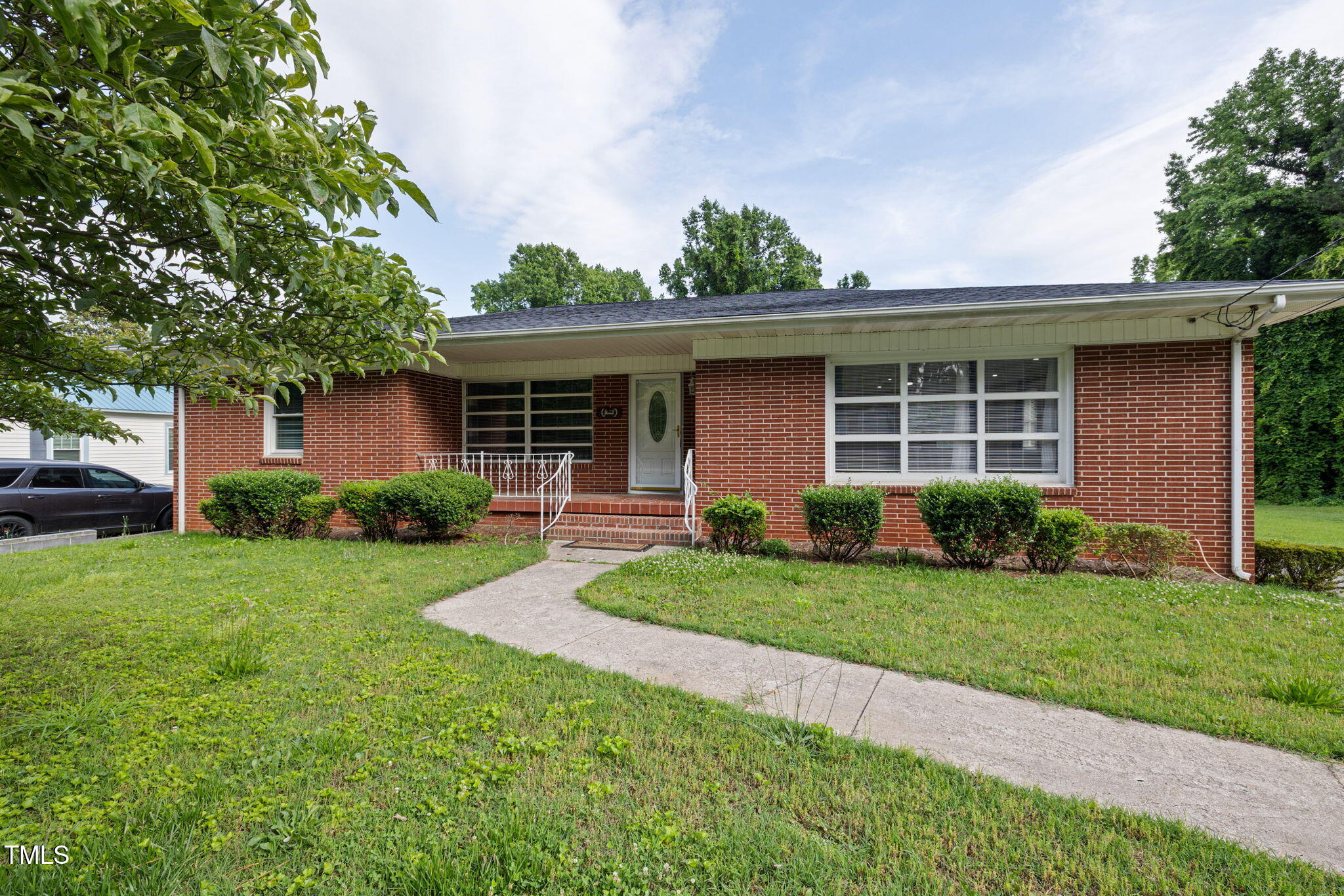 2315 Oxford Road Henderson, NC 27536 - Photo 4 of 62 a front view of a house with a yard