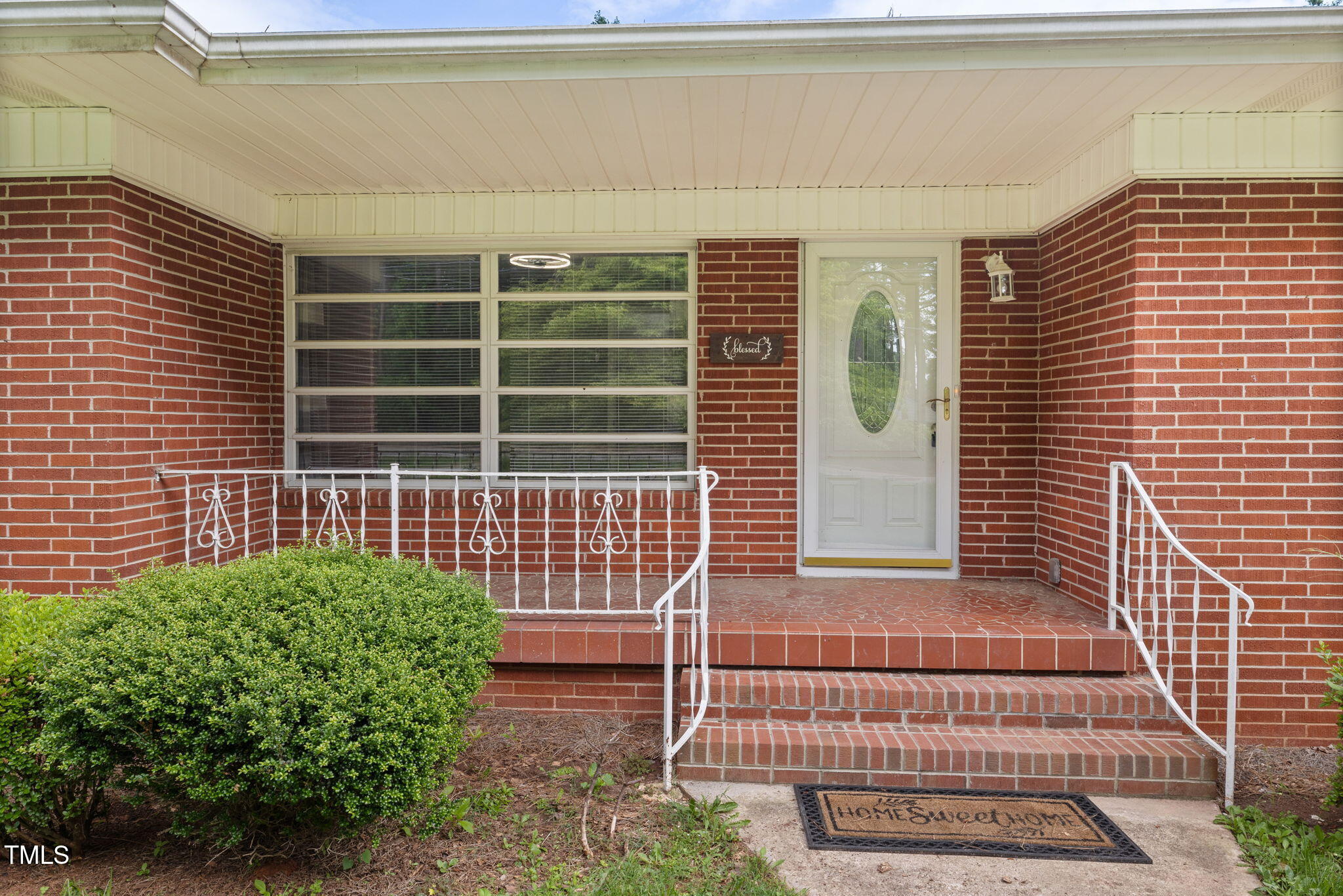 2315 Oxford Road Henderson, NC 27536 - Photo 5 of 62 a front view of a house with a garden