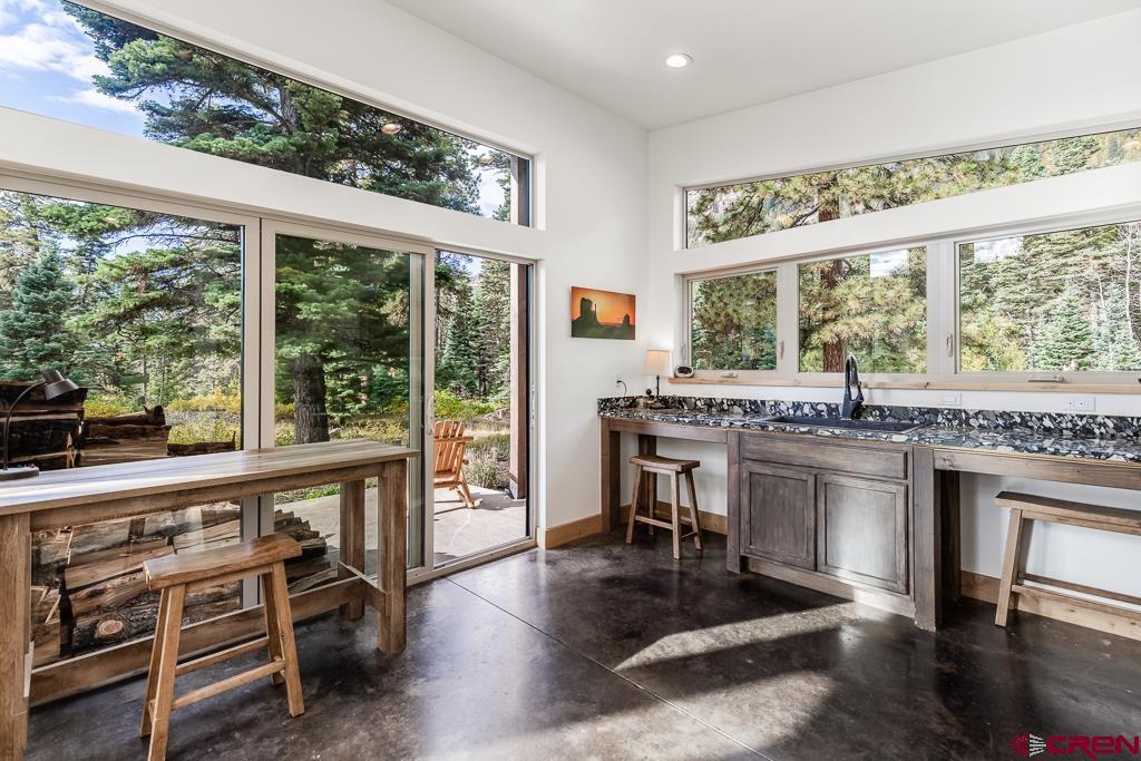 448 Hermosa View Drive Durango, CO 81301 - Photo 13 of 42 a kitchen with stainless steel appliances granite countertop a stove and a table chair