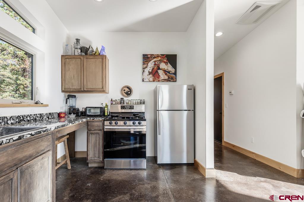 448 Hermosa View Drive Durango, CO 81301 - Photo 16 of 42 a kitchen with stainless steel appliances granite countertop a refrigerator stove and sink