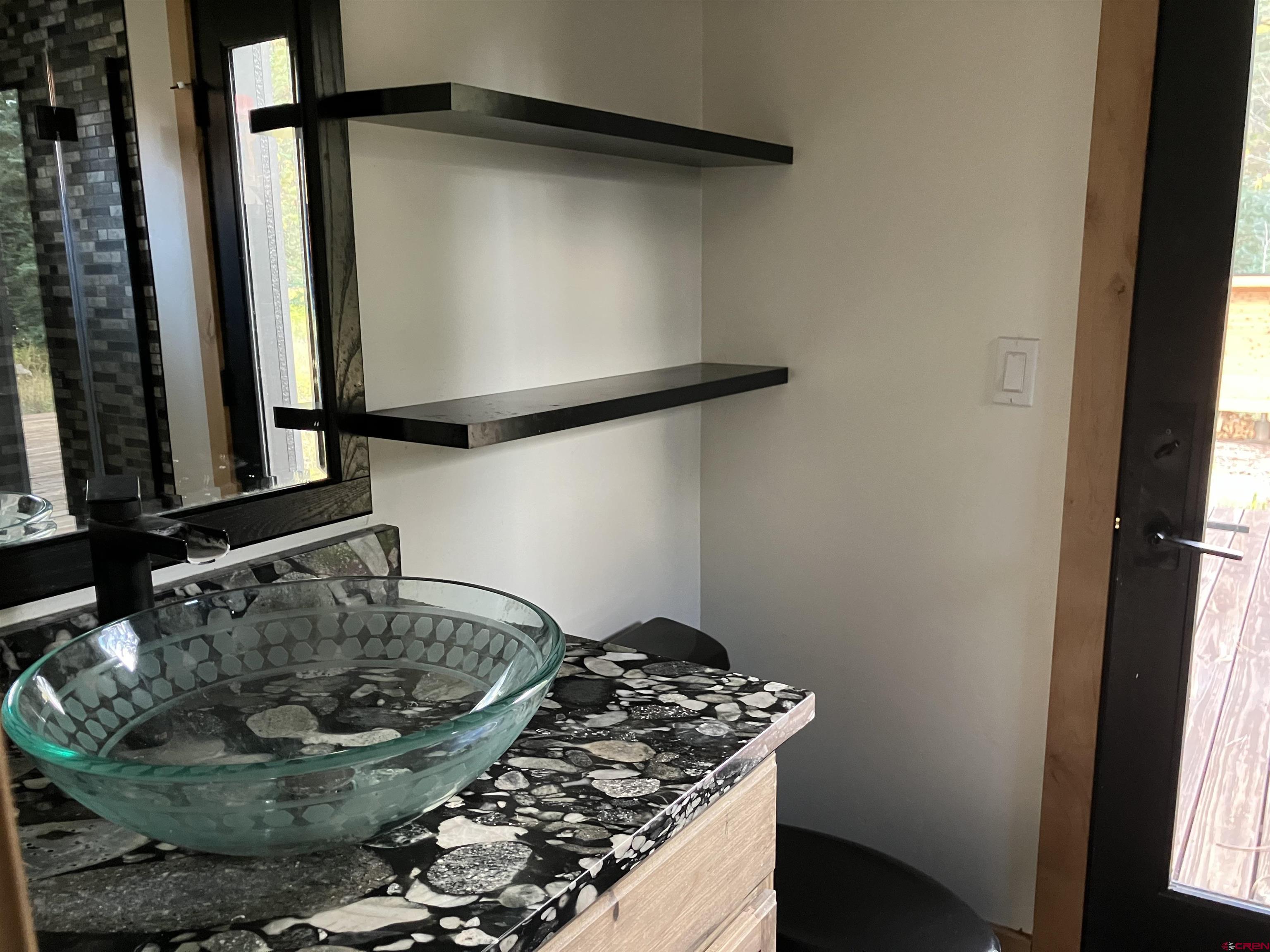 448 Hermosa View Drive Durango, CO 81301 - Photo 25 of 42 a bathroom with a granite countertop sink and a mirror