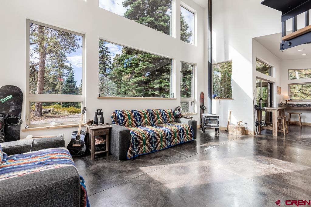 448 Hermosa View Drive Durango, CO 81301 - Photo 6 of 42 a spacious bedroom with a bed couch and a large window