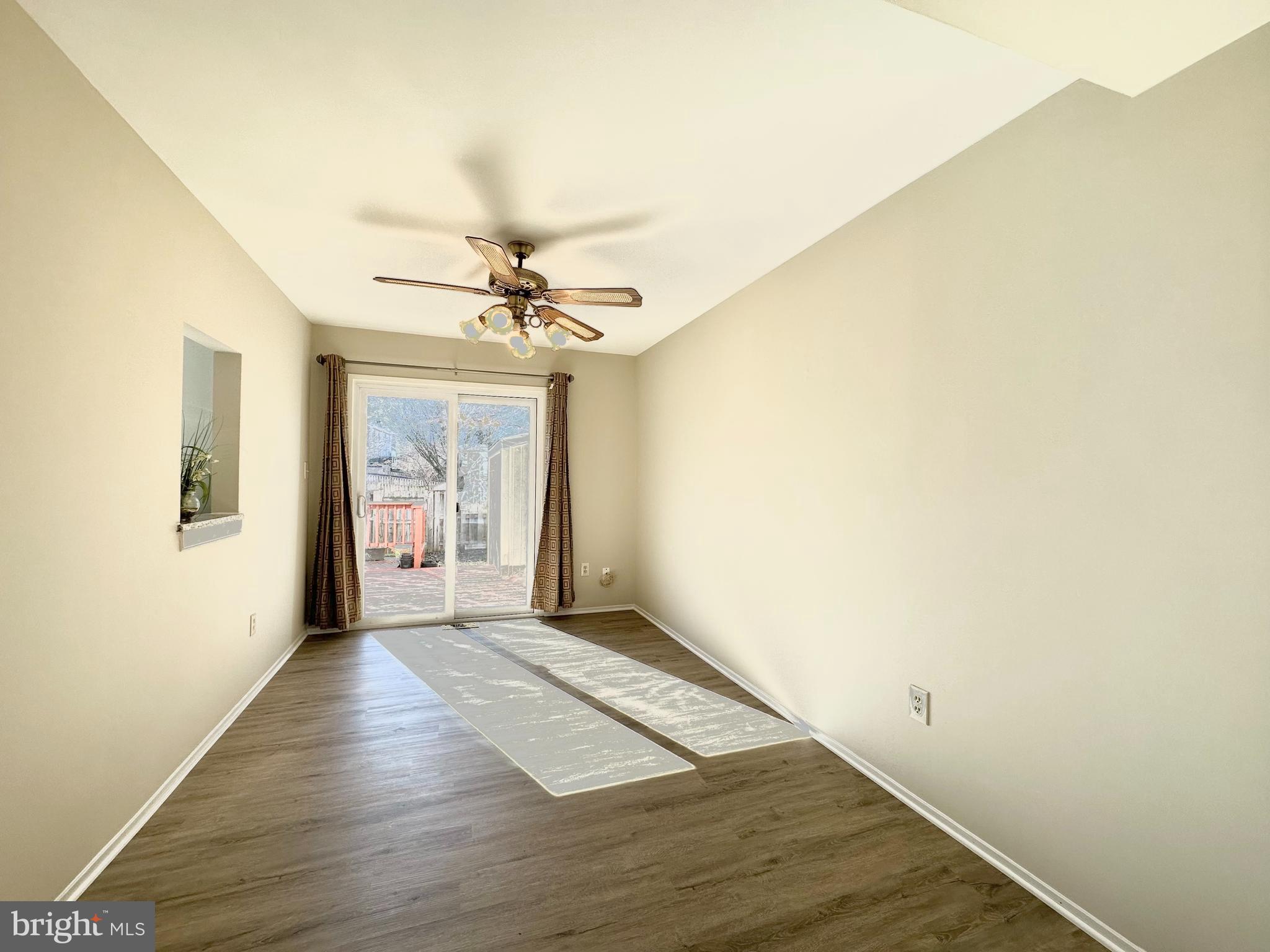 402 Carousel Court Gaithersburg, MD 20877 - Photo 14 of 29 a view of a livingroom with a chandelier fan and wooden floor