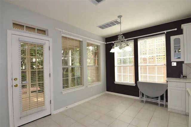 a view of a livingroom with chair and dining table