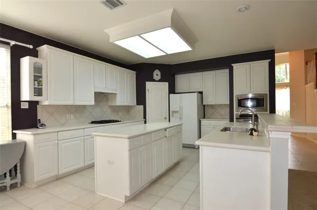 a kitchen with a sink stove and refrigerator