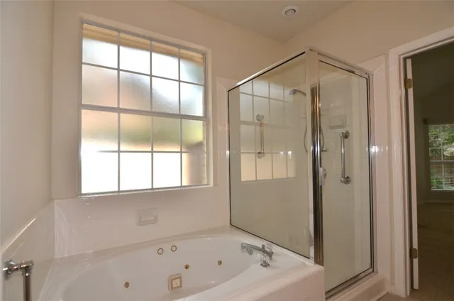 a bathroom with a bathtub and a shower