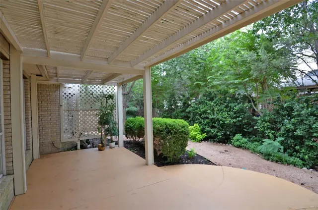 a patio with furniture and garden
