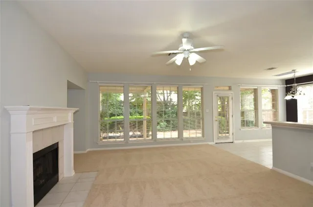 a view of livingroom with furniture fireplace fan and windows