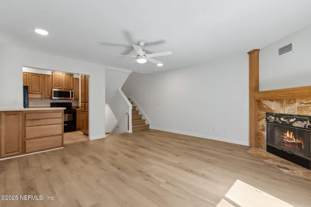 a kitchen with granite countertop a refrigerator stove and microwave