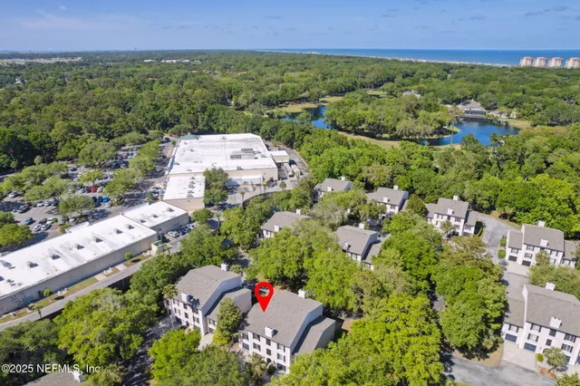 an aerial view of residential house with outdoor space and trees all around