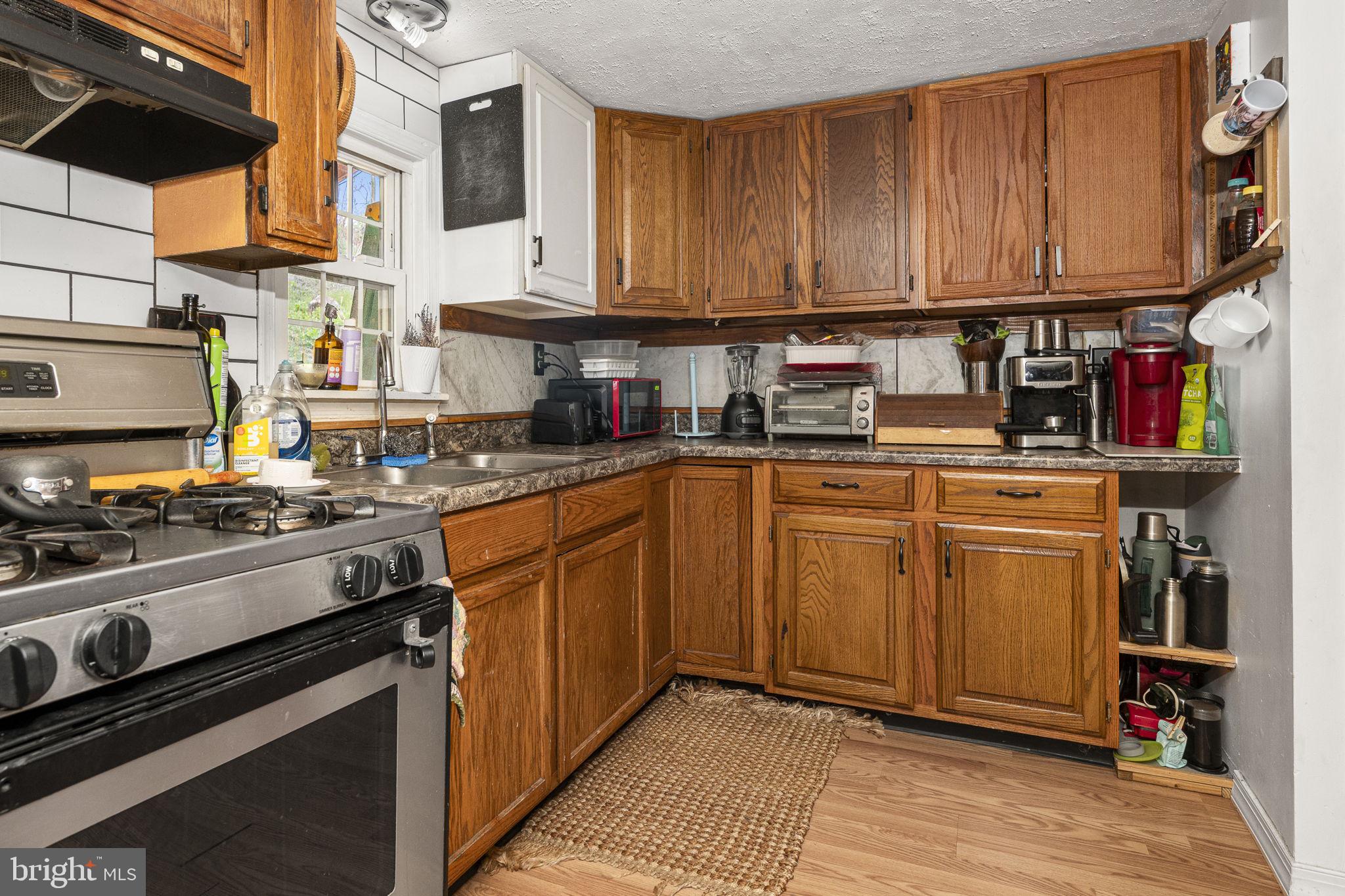 102 Paschall Mill Road West Grove, PA 19390 - Photo 15 of 29 a kitchen with stainless steel appliances granite countertop a stove top oven a sink dishwasher and cabinets with wooden floor