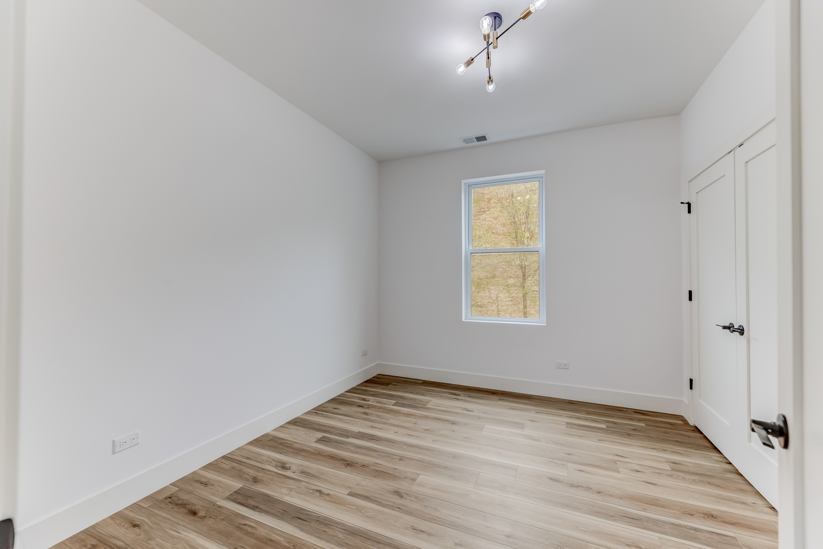 5921 South Calumet Avenue, Unit 2 Chicago, IL 60637 - Photo 15 of 40 wooden floor in an empty room with a window
