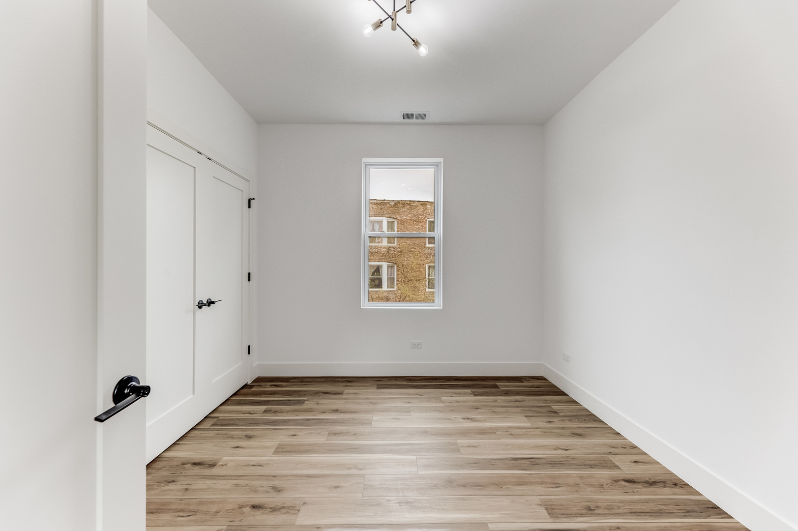 5921 South Calumet Avenue, Unit 2 Chicago, IL 60637 - Photo 28 of 40 a view of empty room with wooden floor and fan