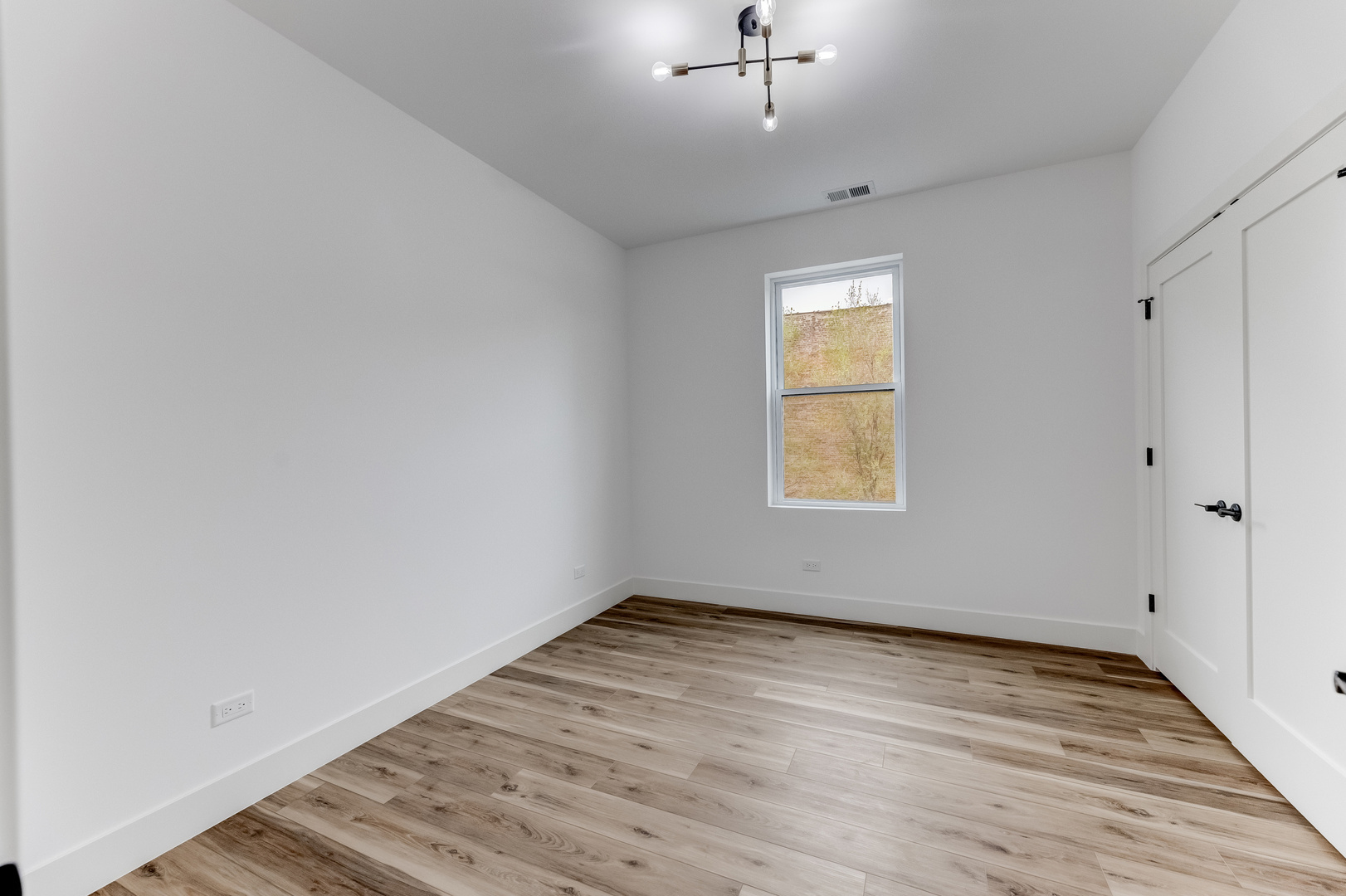 5921 South Calumet Avenue, Unit 2 Chicago, IL 60637 - Photo 30 of 40 wooden floor in an empty room with a window
