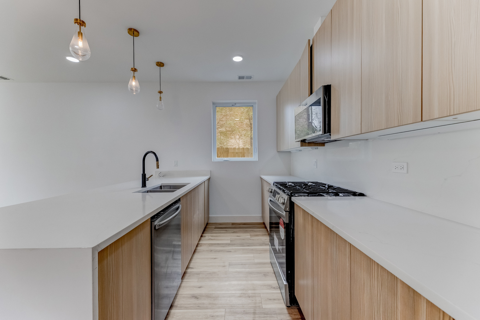 5921 South Calumet Avenue, Unit 2 Chicago, IL 60637 - Photo 7 of 40 a kitchen with stainless steel appliances granite countertop a sink a stove and a wooden floors