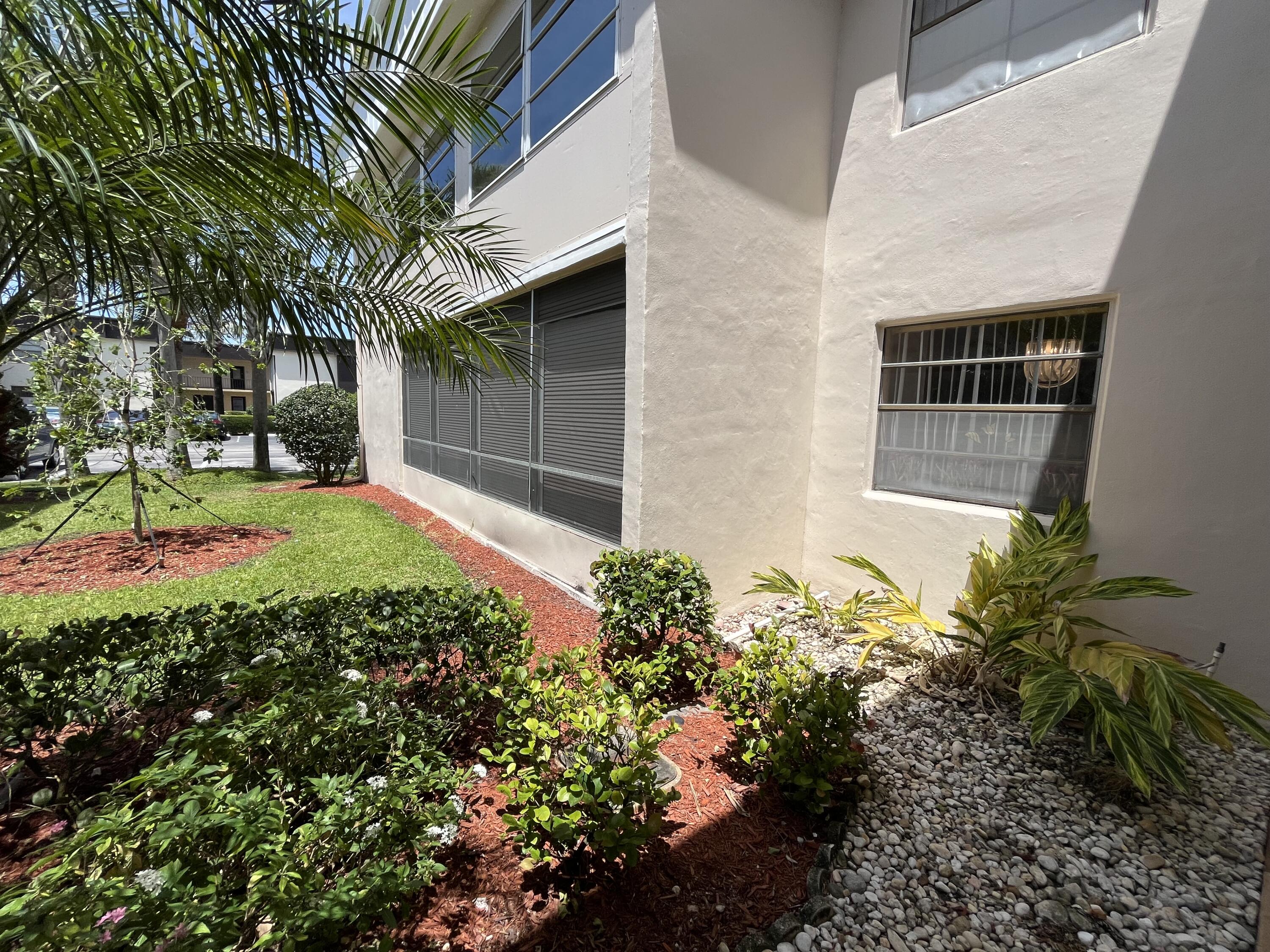 114 Capri B Delray Beach, FL 33484 - Photo 1 of 21 a front view of a house with a yard