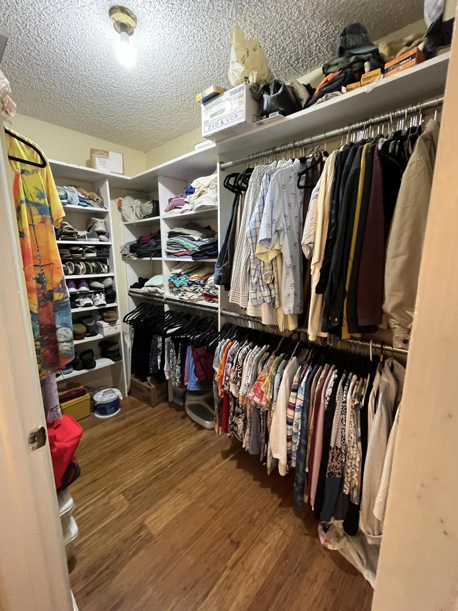 114 Capri B Delray Beach, FL 33484 - Photo 19 of 21 a view of walk in closet with clothes and shoes