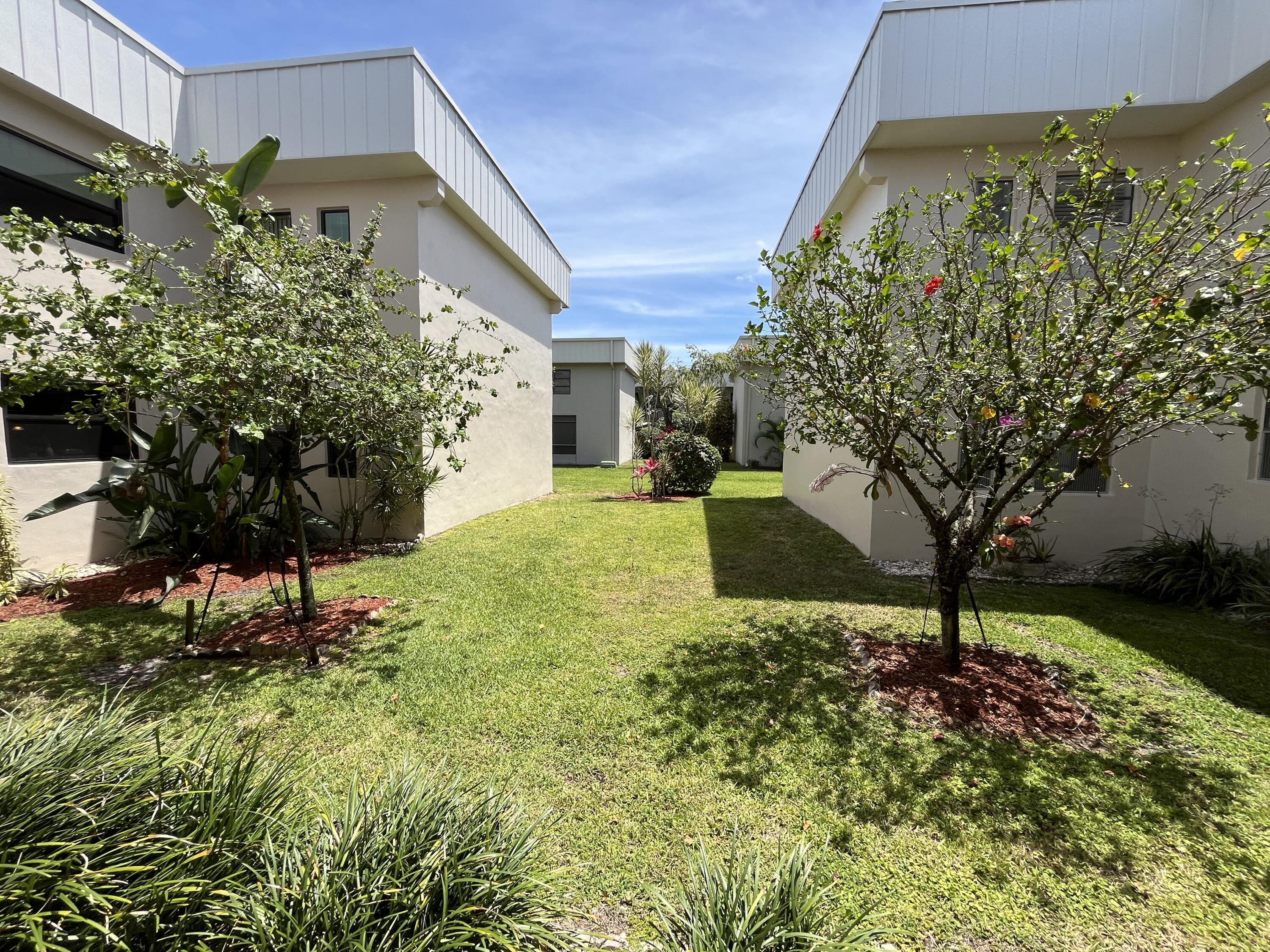 114 Capri B Delray Beach, FL 33484 - Photo 2 of 21 a view of a backyard with garden