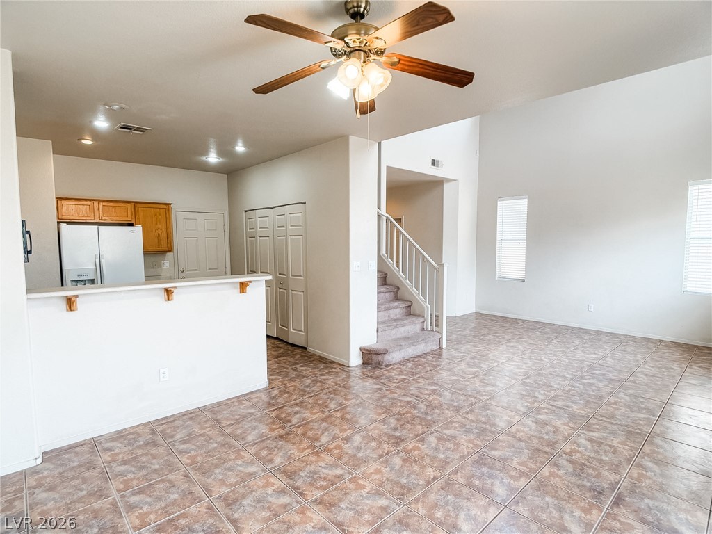 228 Positive Point Street Henderson, NV 89012 - Photo 4 of 27 A naturally illuminated living space boasts high ceilings, a functional kitchen, and easy stair access.