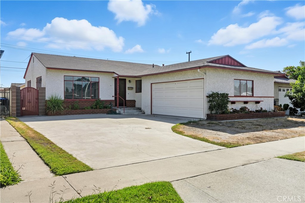a view of a white house with a yard and plants