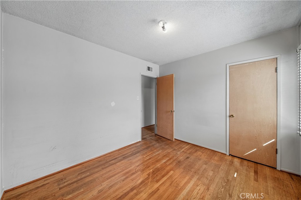 16402 Gridley Road Norwalk, CA 90650 - Photo 15 of 19 a view of an empty room with wooden floor