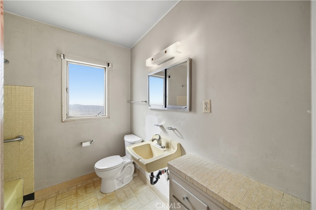 16402 Gridley Road Norwalk, CA 90650 - Photo 19 of 19 a bathroom with a sink toilet and mirror