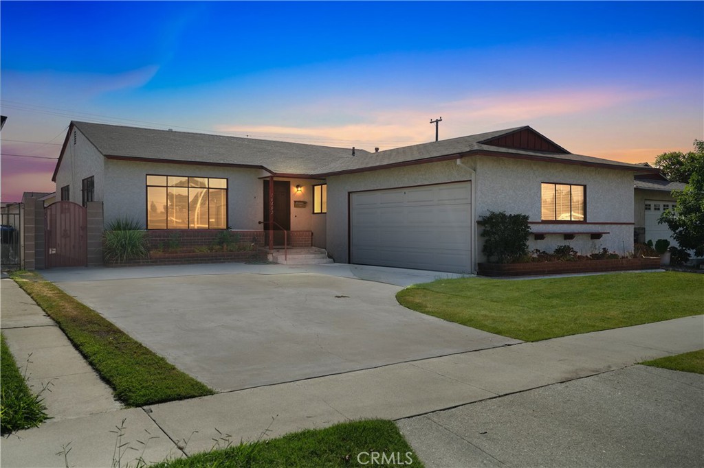 16402 Gridley Road Norwalk, CA 90650 - Photo 2 of 19 a front view of a house with a yard and garage