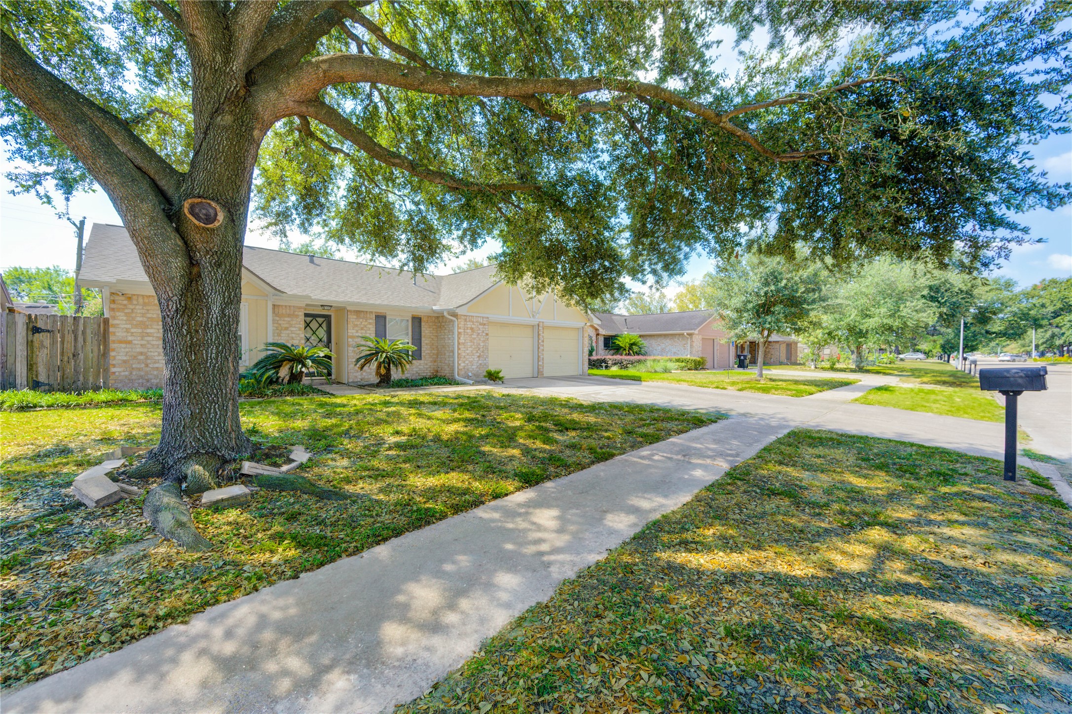 Welcome to 5711 Weeping Willow in Forest Pines, featuring crisp curb appeal and a shaded front walk.