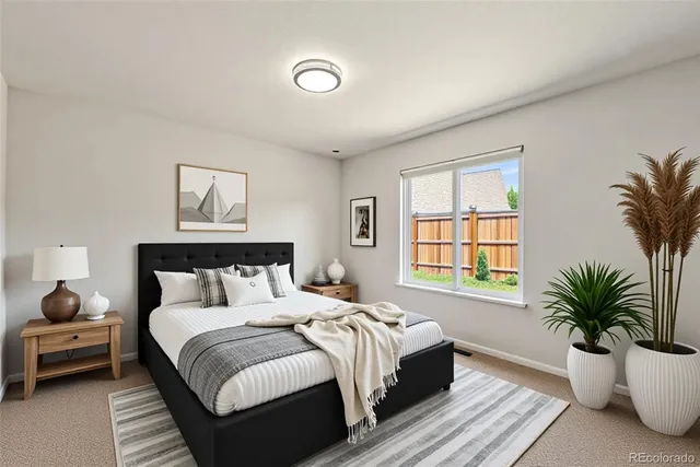 a spacious bedroom with a bed and a potted plant