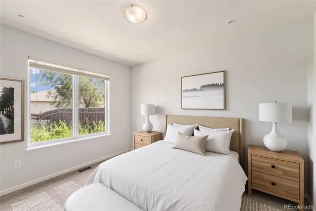 a bedroom with a bed and a large window