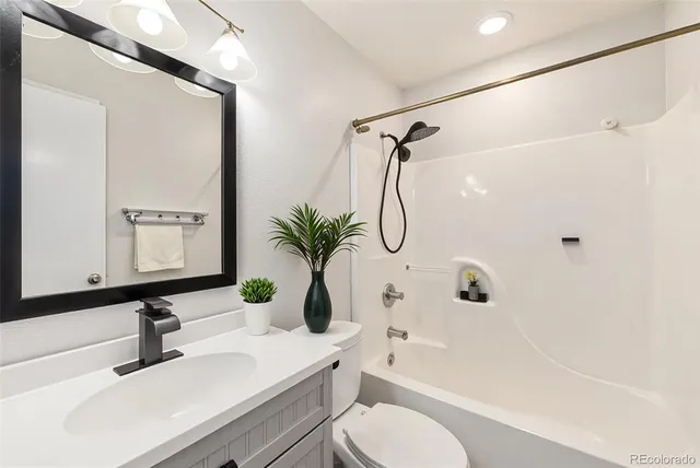 a bathroom with a sink toilet a shower and a mirror