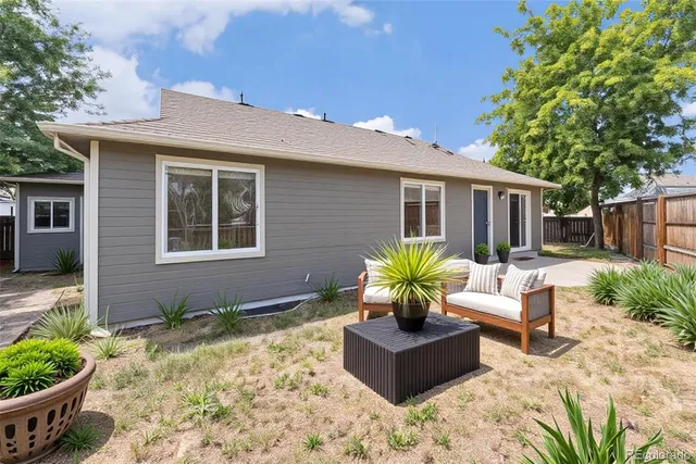 a view of a house with backyard and sitting area