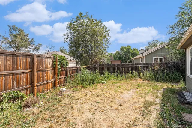 a backyard of a house with lots of green space and lake view