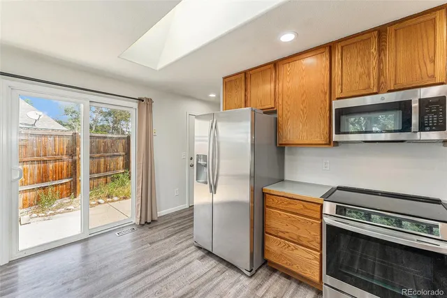a kitchen with stainless steel appliances a stove sink and microwave