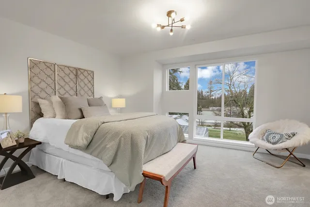 a bedroom with a bed and painting on the wall